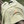 Beige t-shirt with 'Built with Conviction' text on a wooden surface