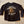 Black long-sleeve shirt with eagle graphic and text on a concrete surface