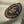Close-up of a patch on a beige fabric with text and branding.