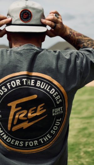 Person wearing a cap and t-shirt with branding text