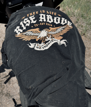 Black tee with 'Free is Life, Rise Above' text and eagle design on a motorcycle.